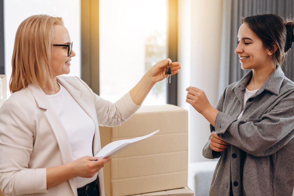 Landlord handing rental-property keys to a new tenant
