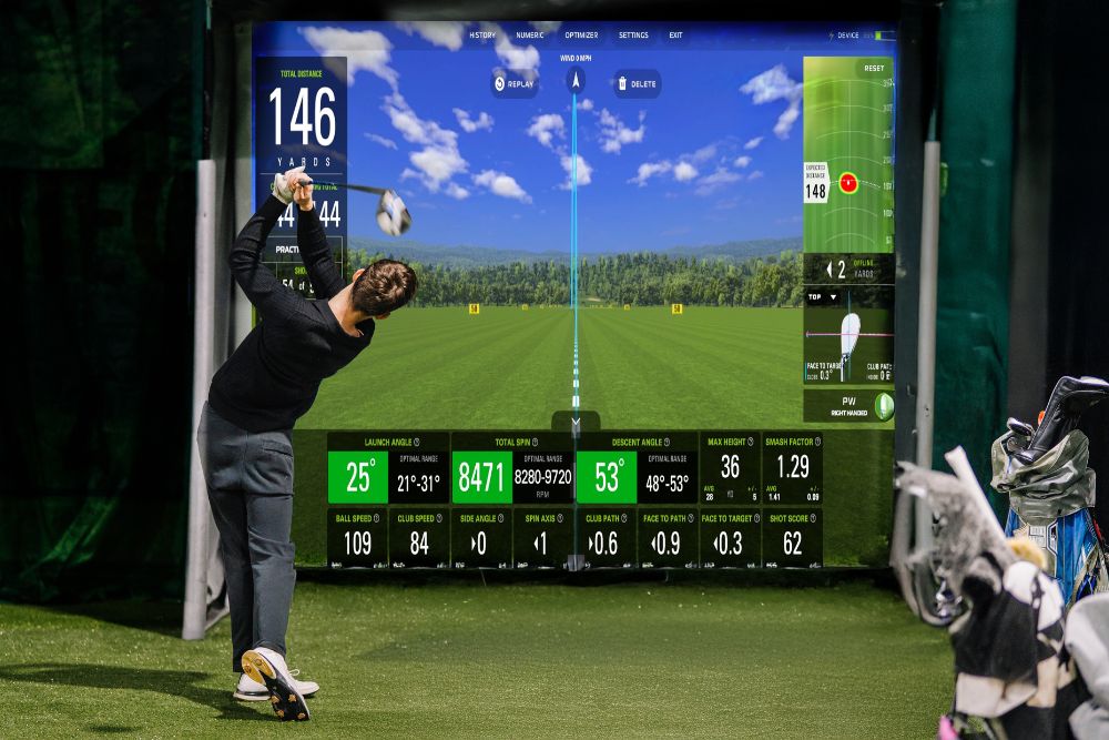 Golfer using an indoor residential golf simulator